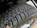 Close-up of a tire tread from a 2017 Chevrolet Express showing deep grooves and signs of wear with some debris visible on the surface