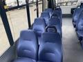 Interior seats of a 2018 Chevrolet Express with blue fabric upholstery and handles on the seat backs