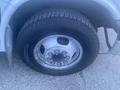 Close-up of a tire and wheel of a 2017 Chevrolet Express van showing tread pattern and silver alloy rim