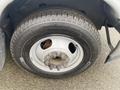 A close-up of a wheel and tire from a 2017 Chevrolet Express showing a silver rim and Michelin tire tread