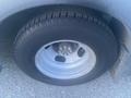 A close-up view of a tire on a 2017 Chevrolet Express showing the wheel rim and tire tread detail