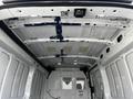 Interior view of a 2020 Ford Transit van with a bare ceiling featuring metal support beams and lights installed