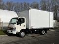 A 2015 Hino 195 truck with a white box cargo body parked at a slight angle facing forward