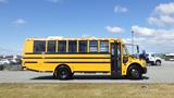 A 2014 Freightliner Thomas diesel school bus in bright yellow with black stripes and large windows, displayed from the side