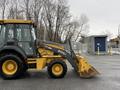 2011 John Deere 310SJ 4x4 Wheel Loader with an extended hoe and a 4 in 1 bucket positioned on a construction site