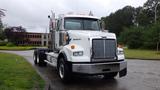 2019 Western Star Trucks 4900 with a white body and chrome accents positioned frontally showcasing its large grille and prominent headlights