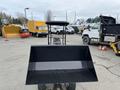 A 2024 AGT Industrial KRW23 Mini Loader with a large black bucket facing forward