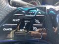 Close-up of control buttons on the steering wheel of a 2025 Mercedes-Benz Sprinter including settings for cruise control and various functions