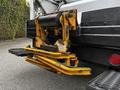 The image shows the rear hydraulic lift mechanism of a 2014 Hino 195 truck with metal arms and a black cylinder attached