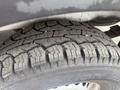 Close-up of a tire from a 2009 Dodge Sprinter Van showing a tread pattern designed for traction and stability