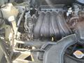 Close-up of a 2019 Nissan NV200 engine with visible components such as the intake manifold and various hoses and connectors