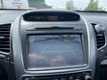 Dashboard display of a 2015 Kia Sorento showing a rearview camera with guiding lines and warning text