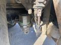 Close-up of a hydraulic filter assembly mounted under a 2014 International 7400 truck showing dirt and wear from use