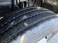 A close-up of a worn tire from a 2014 Hino 195 showing visible tread wear and exposed grooves