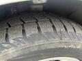 Close-up of a tire from a 2017 Ford Transit Connect showing tread pattern and rubber detail