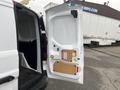 A white 2017 Ford Transit Connect van with an open rear door showing its interior and cargo space