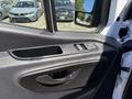 Interior door panel of a 2019 Mercedes-Benz Sprinter featuring a black handle and window control buttons