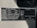 A metal identification plate from a 2009 Ford F-550 displaying specifications such as height length and gross vehicle weight rating