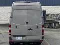 A gray 2010 Mercedes-Benz Sprinter van viewed from the rear with a smooth metallic finish and the brand logo prominently displayed in the center