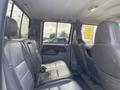Interior of a 2007 Ford F-350 SD showing a spacious back seat area with black leather upholstery and a single headrest on each seat
