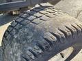 Close-up of a worn tire from a 2010 Kubota F3990 with visible tread patterns and some dirt and wear on the surface