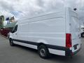 A white 2025 Mercedes-Benz Sprinter van viewed from the side with a high roof and rear doors closed