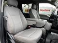 Two front seats of a 2020 Ford F-350 with cloth upholstery and a center console between them