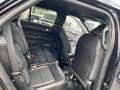 Interior of a 2021 Ford Explorer showing the rear seating area with black leather seats and seat belts