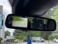 A rearview mirror displaying a rear camera image showing lane markings and a vehicle behind a 2017 Ford Transit 350