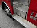 Close-up view of a 1991 Sutphen Deluge fire truck featuring textured metallic steps and a storage compartment with a latch
