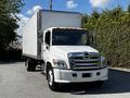 A white 2021 Hino 338 box truck with a silver front grille and orange reflective strips on the roof