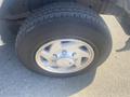 A close-up view of a tire mounted on a silver rim from a 2009 Ford Econoline with visible tread patterns