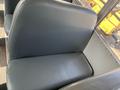 A close-up view of a gray upholstered seat in a Blue Bird Vision bus