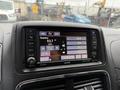 A digital display in a 2017 Dodge Grand Caravan showing radio stations and a time readout