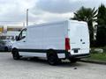 A 2021 Mercedes-Benz Sprinter van with a white exterior and rear cargo doors parked in a lot