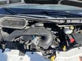 Engine compartment of a 2016 Ford Transit showcasing the engine components and configurations including hoses and battery