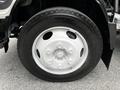 Close-up of a white wheel with a five-bolt pattern mounted on a 2018 Isuzu NPR truck tire
