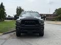 A 2024 RAM 2500 truck is shown head-on with a black exterior and prominent grille featuring the RAM logo