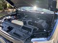 A 2015 Ford F-150 engine compartment showing the engine, battery, and various components with a closed hood