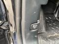 A close-up of a pull lever in a 2021 Ford Explorer designed to open the rear hatch with a label indicating to pull twice