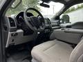 Interior view of a 2020 Ford F-350 SD showing the steering wheel dashboard and front passenger seat with fabric upholstery