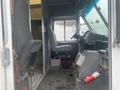 Interior view of a 2012 Ford Econoline with front seats visible and the driver's dashboard in focus