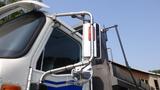 A 2003 International 5600i truck with chrome mirrors and light fixtures attached to the side of the cabin