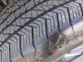 Close-up of a tire from a 2022 Ford F-150 showing the tread pattern and surface detail