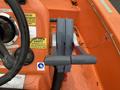 A control lever for steering on a 2008 Fassmer 20 Foot Fast Rescue boat with an orange surface and various safety stickers nearby