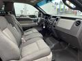 Interior view of a 2010 Ford F-150 showcasing two front seats and the dashboard with controls and displays