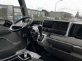 Interior view of a 2021 Mitsubishi FE showing the steering wheel dashboard gear shift and controls