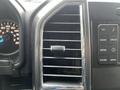 Interior dashboard of a 2016 Ford F-150 featuring a speedometer and an air vent with accompanying control buttons for media and phone settings