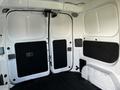 Interior view of a 2017 Nissan NV200 showcasing the cargo area with dual rear doors and a black rubber floor mat