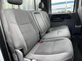 Interior view of a 2007 Ford F-550 with gray fabric seats arranged in a bench configuration and seat belts visible